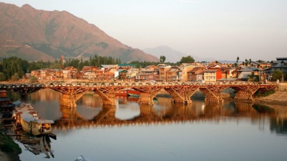In front of the old town of Srinagar, India, houseboats are rocking on the waters of the Jhelum River