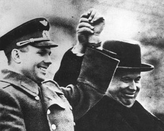 Gagarin, with the first man of the Soviet Union, party secretary Nikita Khrushchev, greets the people from a decorative tribune placed on top of the Lenin Mausoleum.